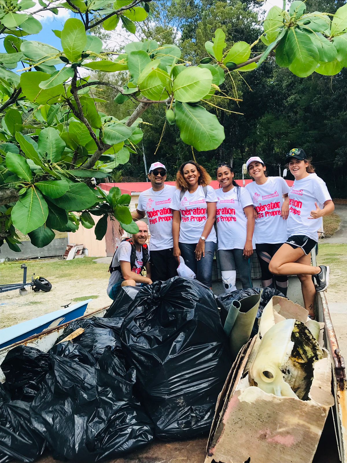Group of six volunteers in a dumpster at the 21st edition of Operation Clean Country.